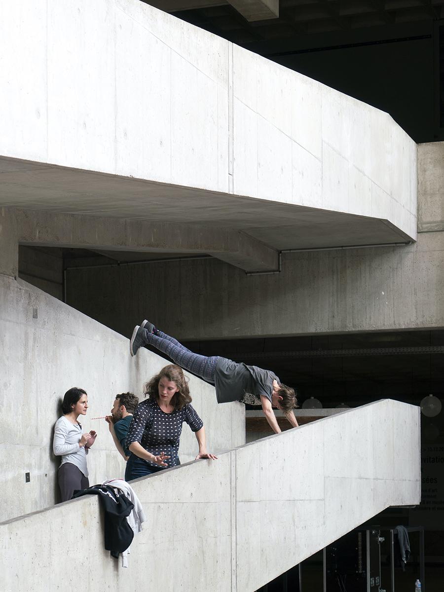 dancers on a concrete building dancing within the architectural space