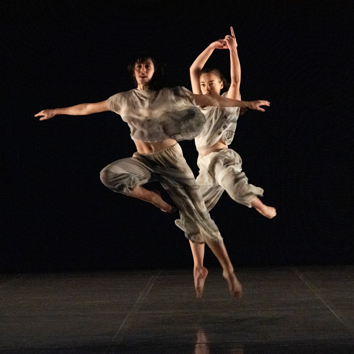 Dancers jumping in Set and reset by Trisha Brown