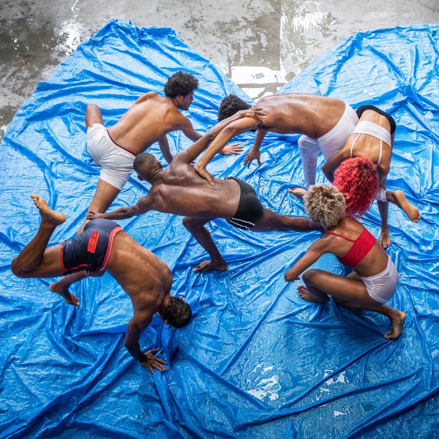Dancers on a blue tarp