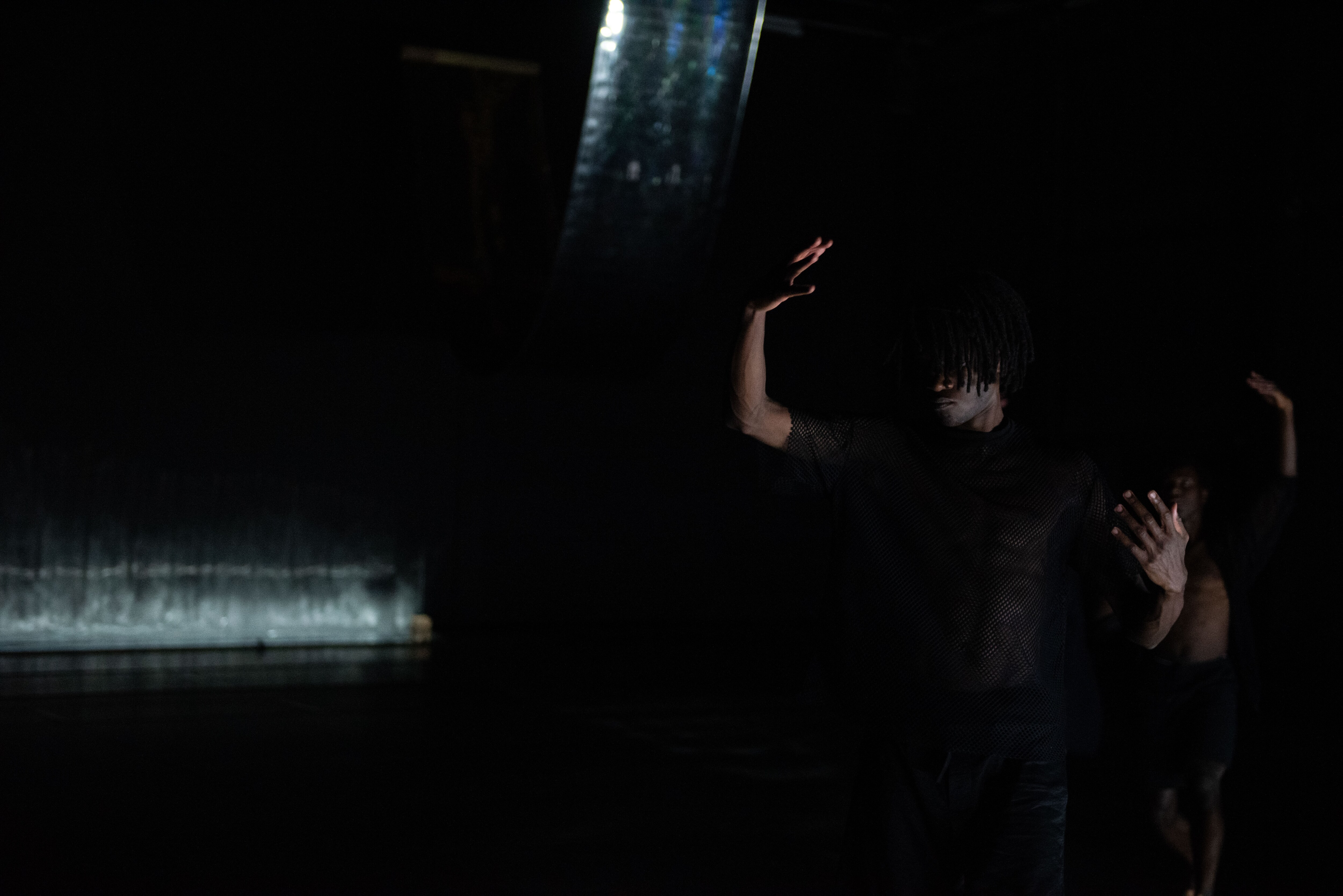 A dancer on a dark stage