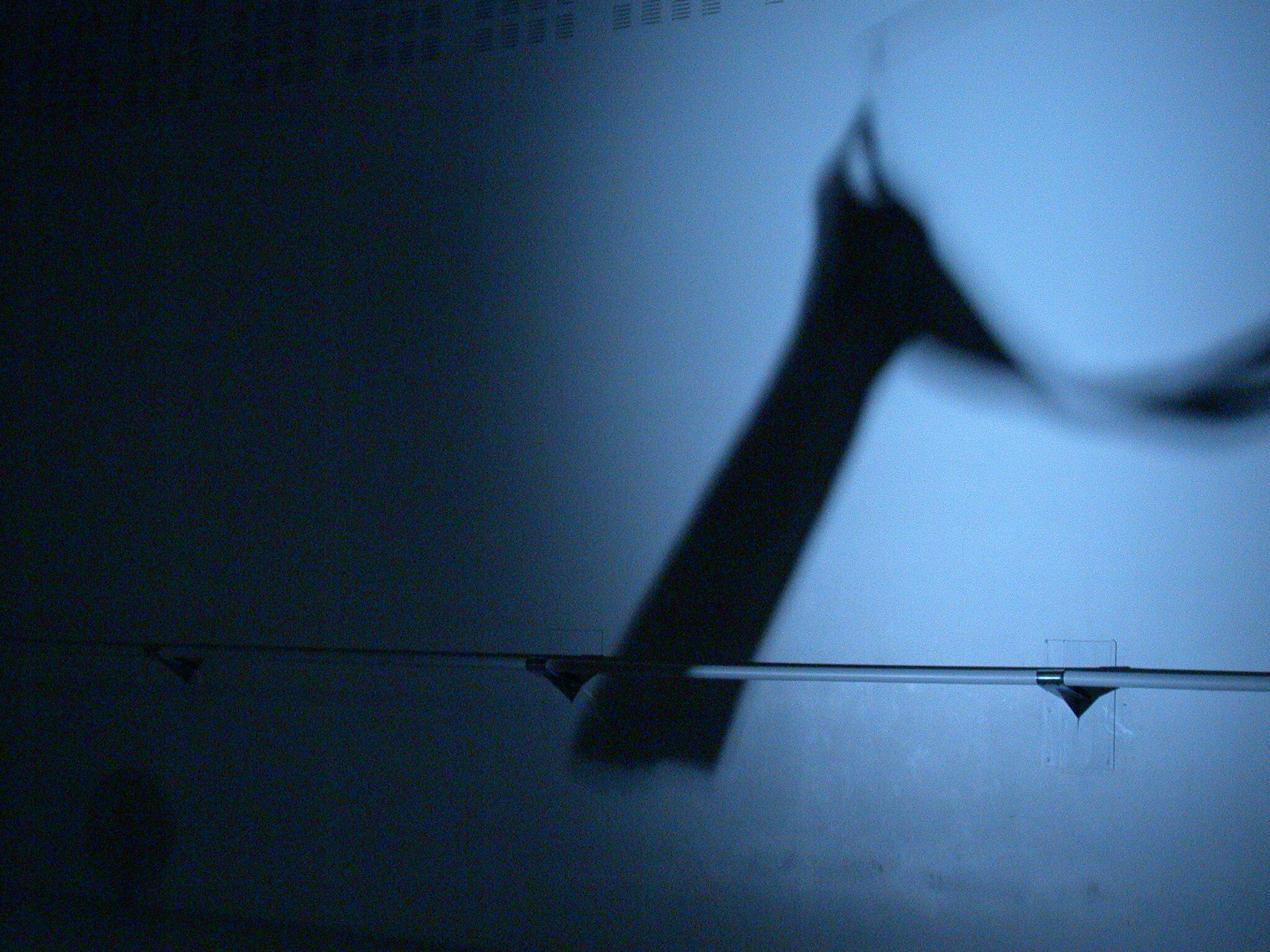 a shadow of a dress hanging from a hanger