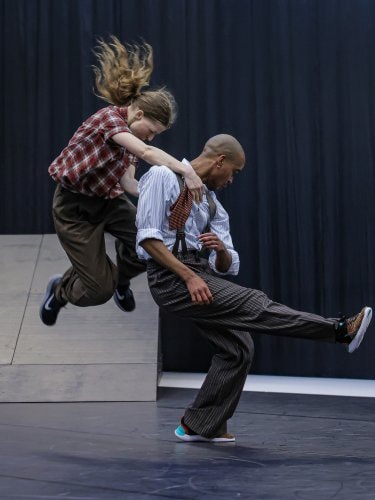 Two dancers jumping. 