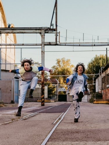 choreographers running and shouting in a street 