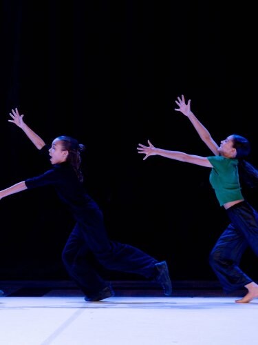3 dancers performing on stage