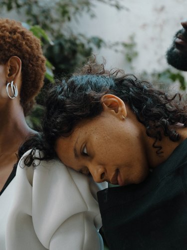 Two women lying on the shoulder on the one in the center 