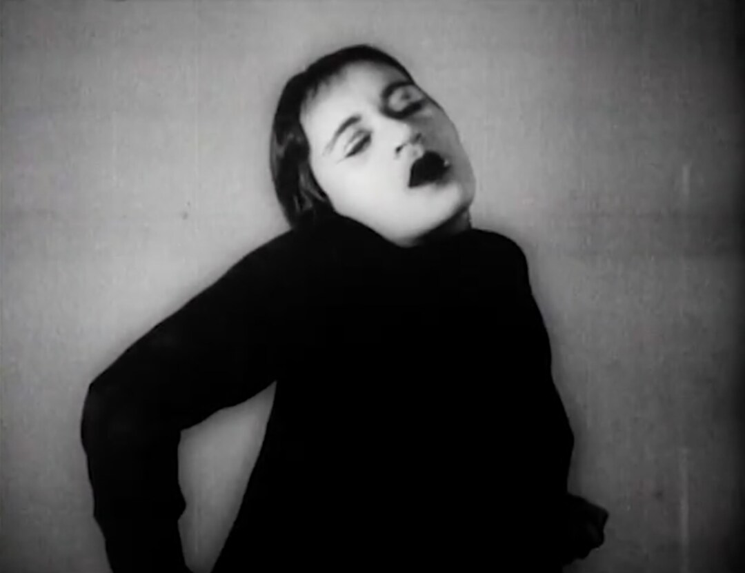 black and white photo of a woman with eyes closed, head resting on her shoulder