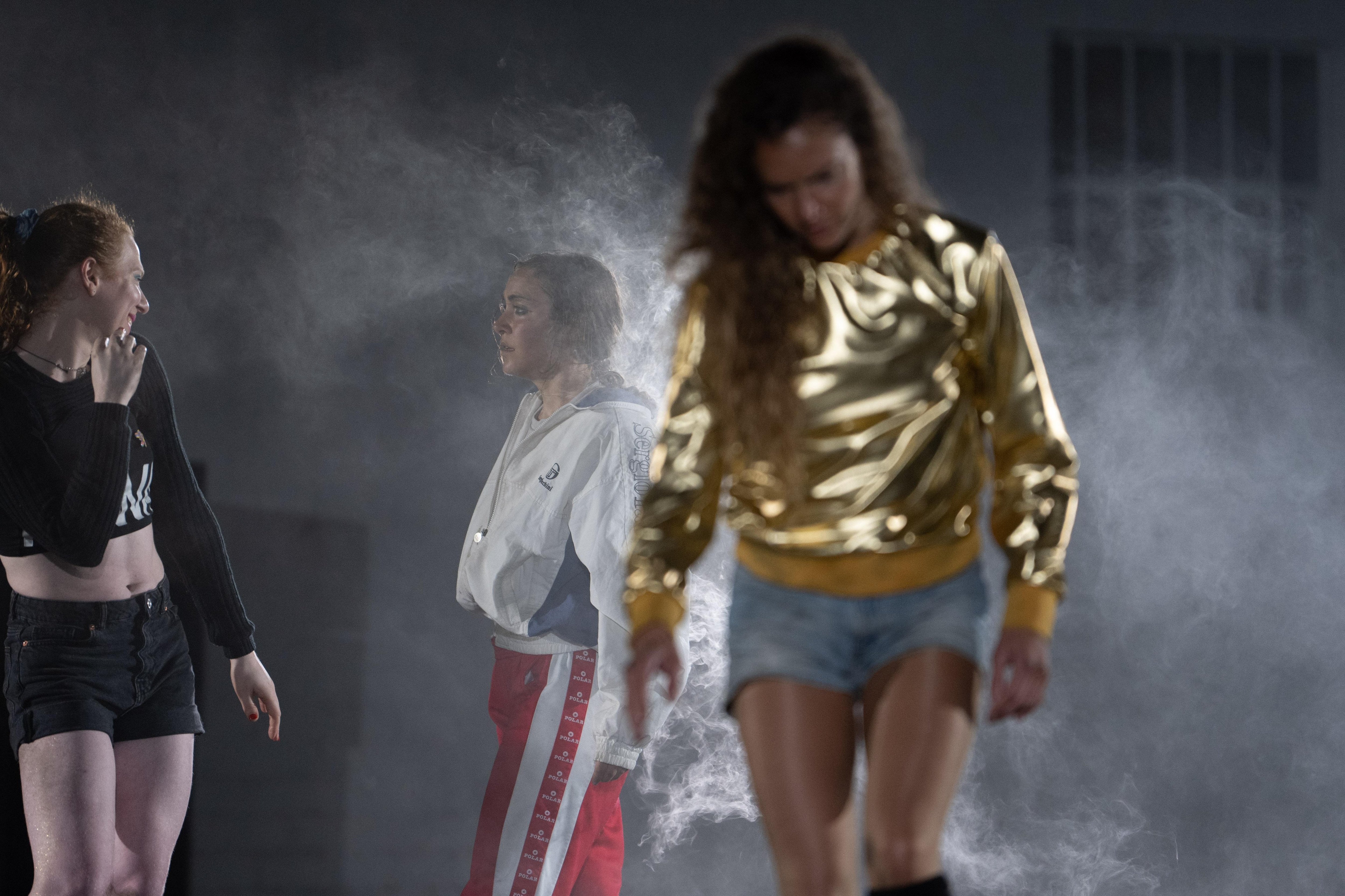 three women standing in smoke