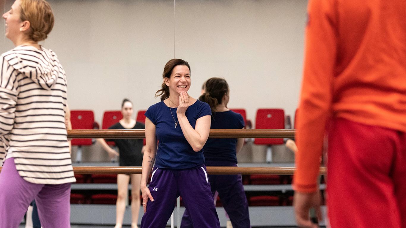 Pam Tanowitz smiling in front of dancers  