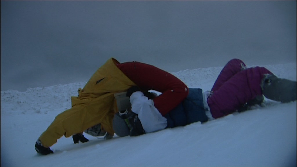 two men on the ground, one holding the legs of the other