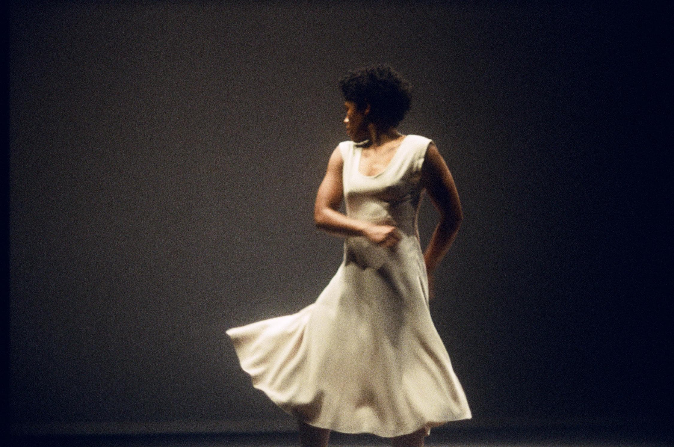 Dancer in white dress looking back