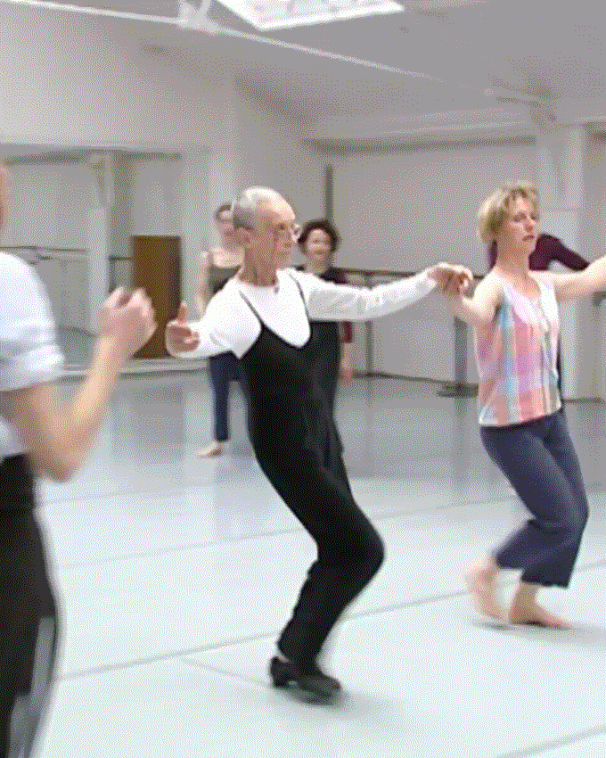 Françoise Dupuy walking with another dancer, arms spread out