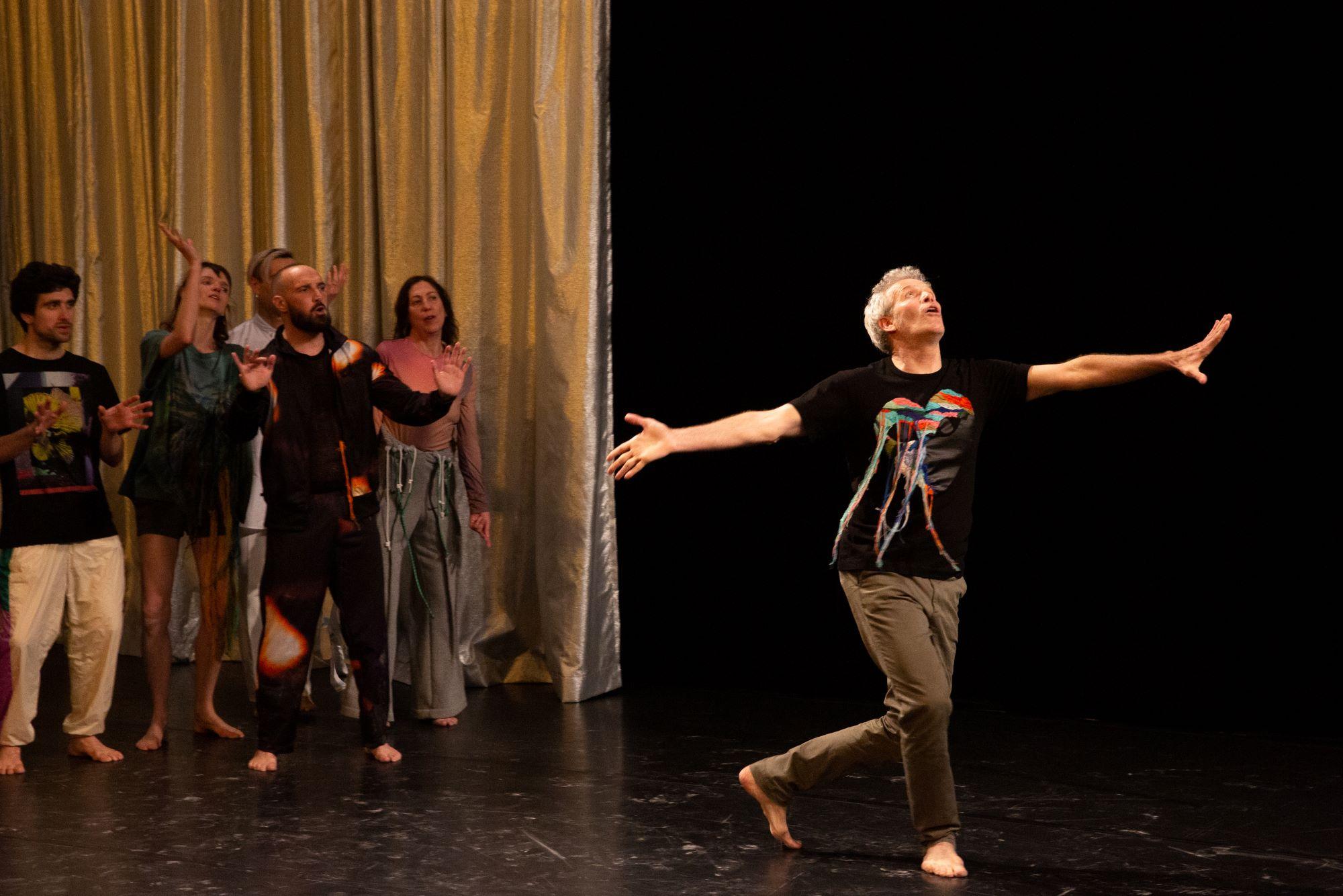 One dancer holding the arm of another dressed in white