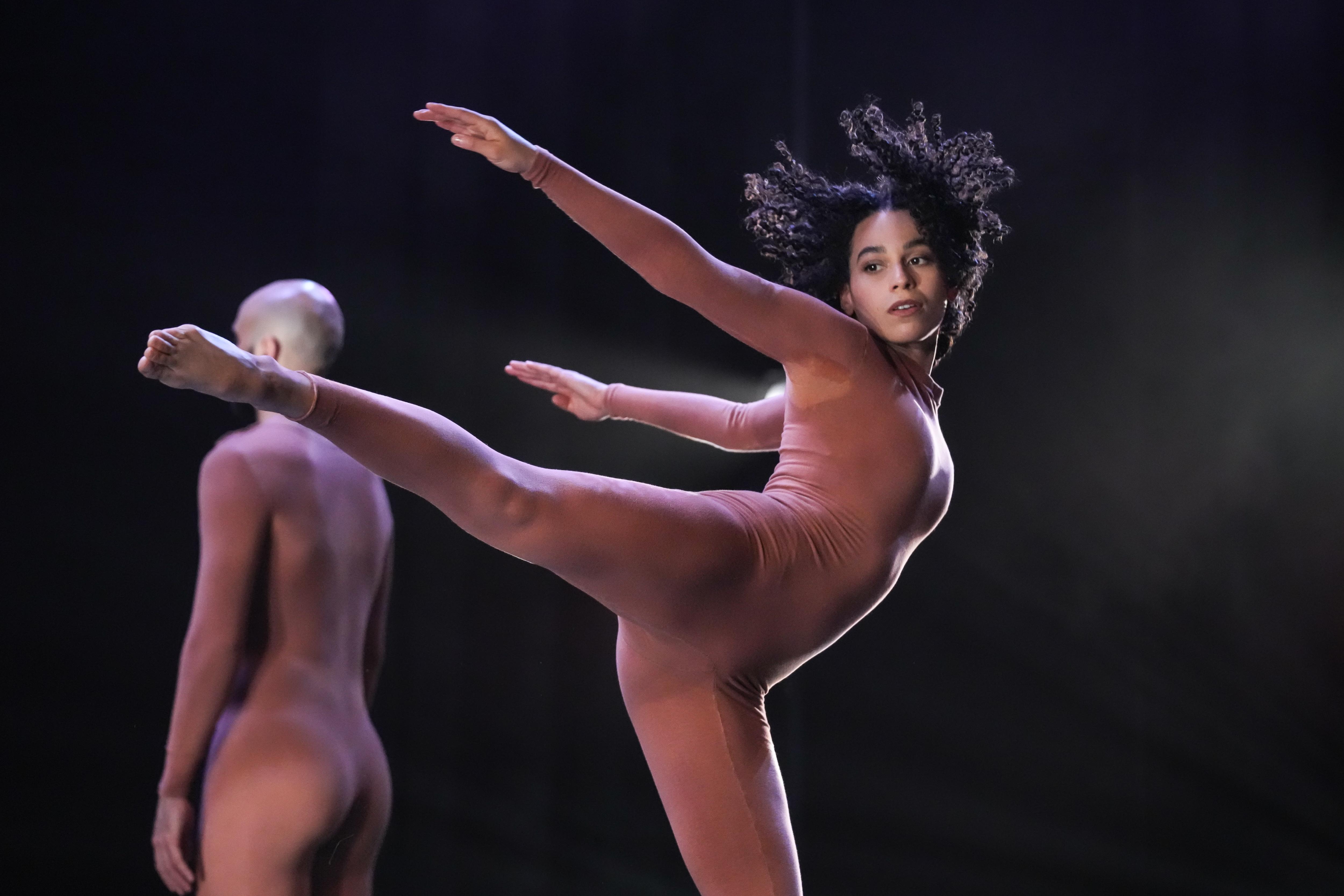 Two dancers in full terracotta leotards