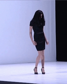 Woman in a black dress and heels falling and coming back up