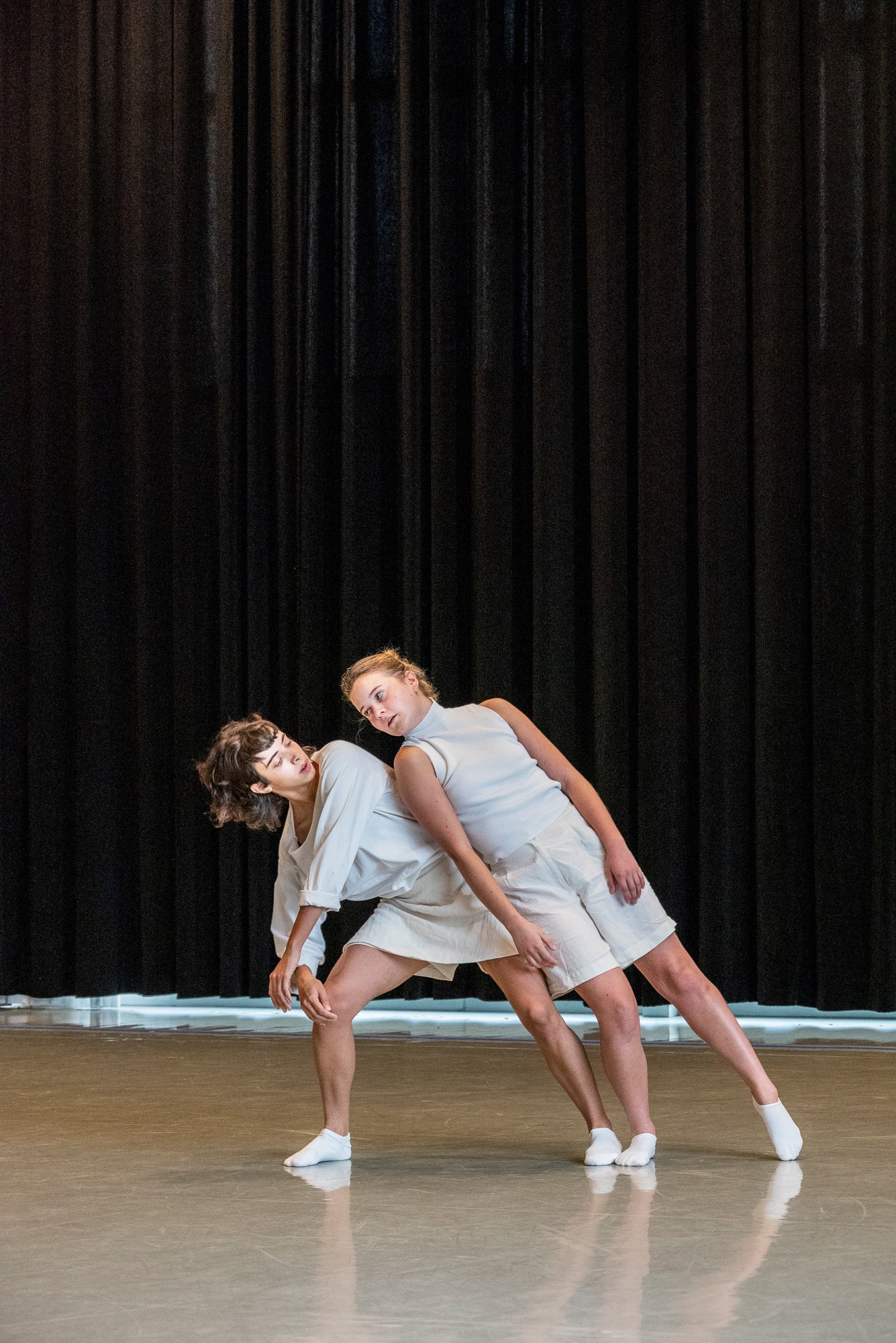 Une danseuse mettant son poid sur une autre danseuse