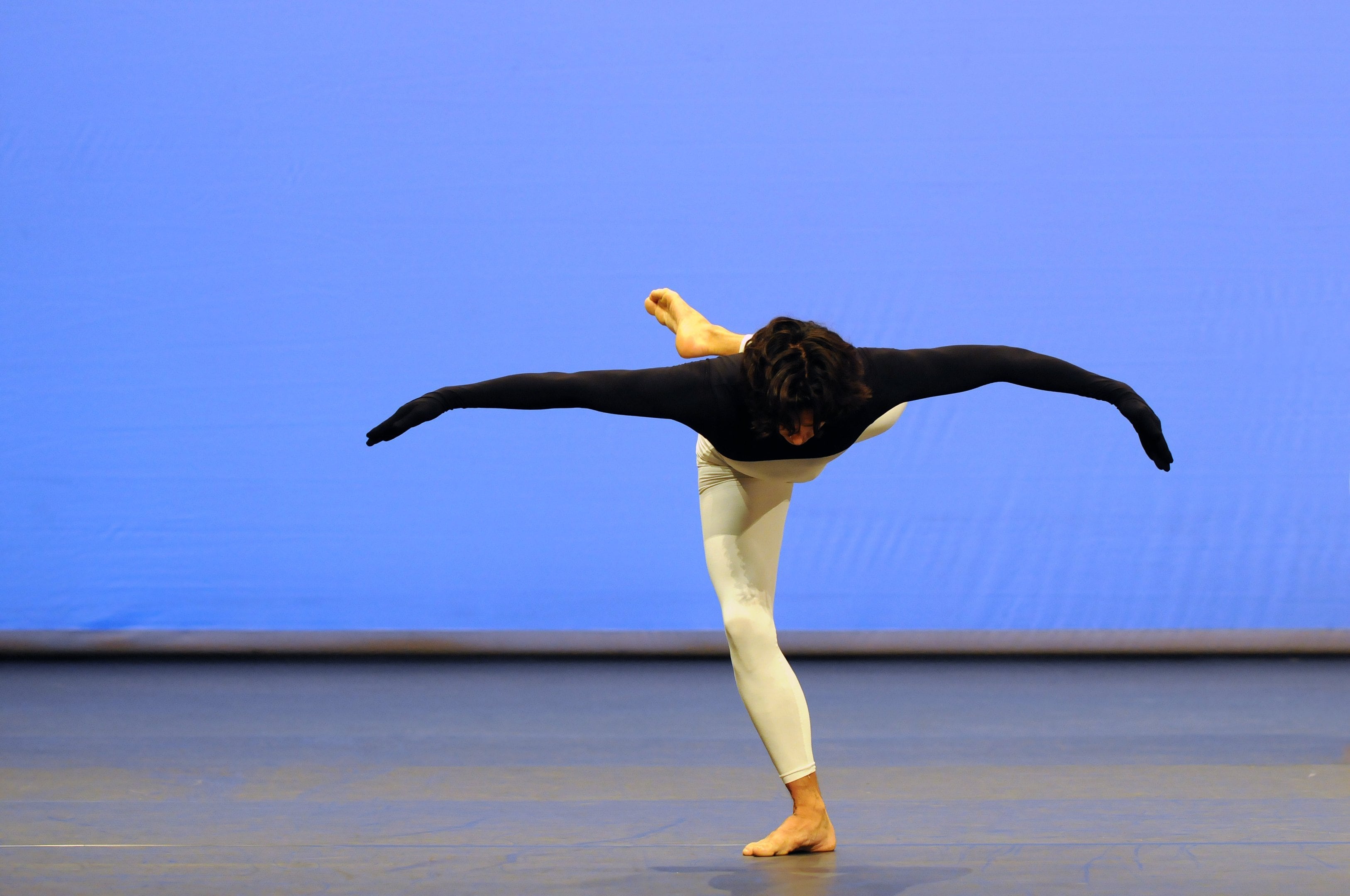 dancer in arabesque on a blue background