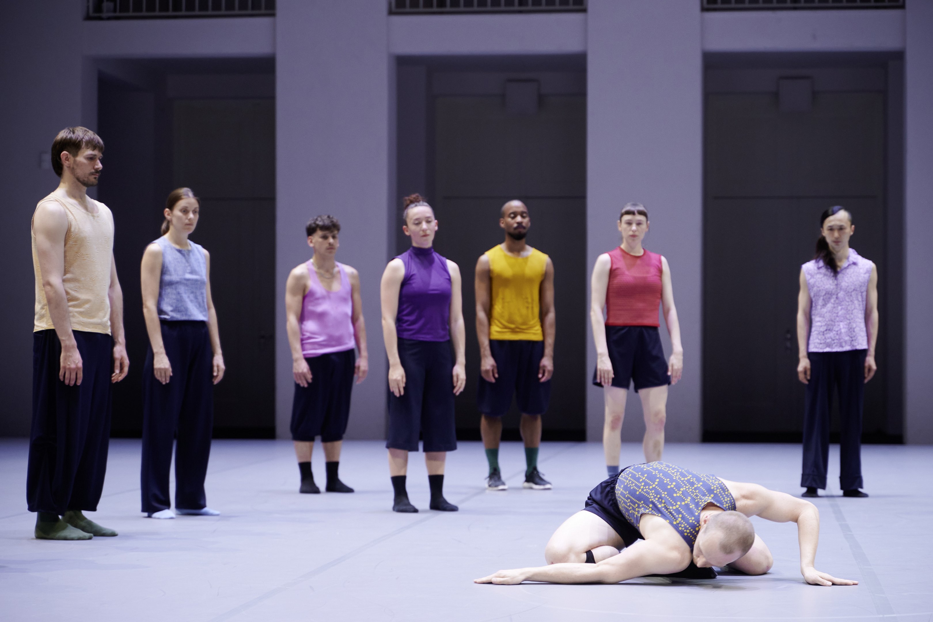 A group of dancers are watching another dancer on the floor