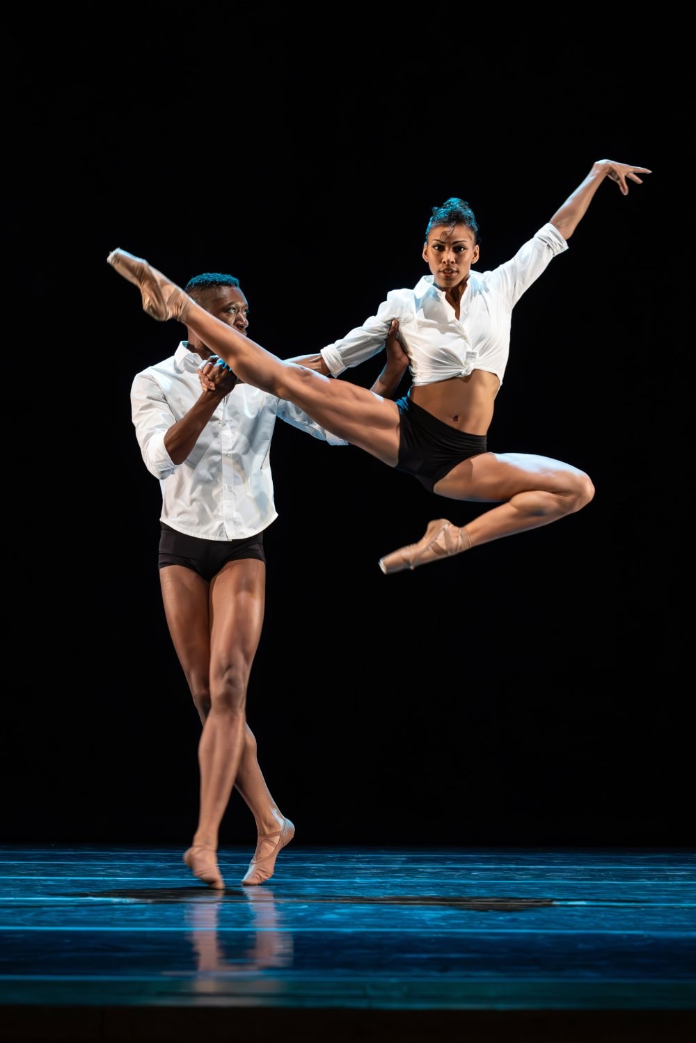 2 dancers on stage performing a lift