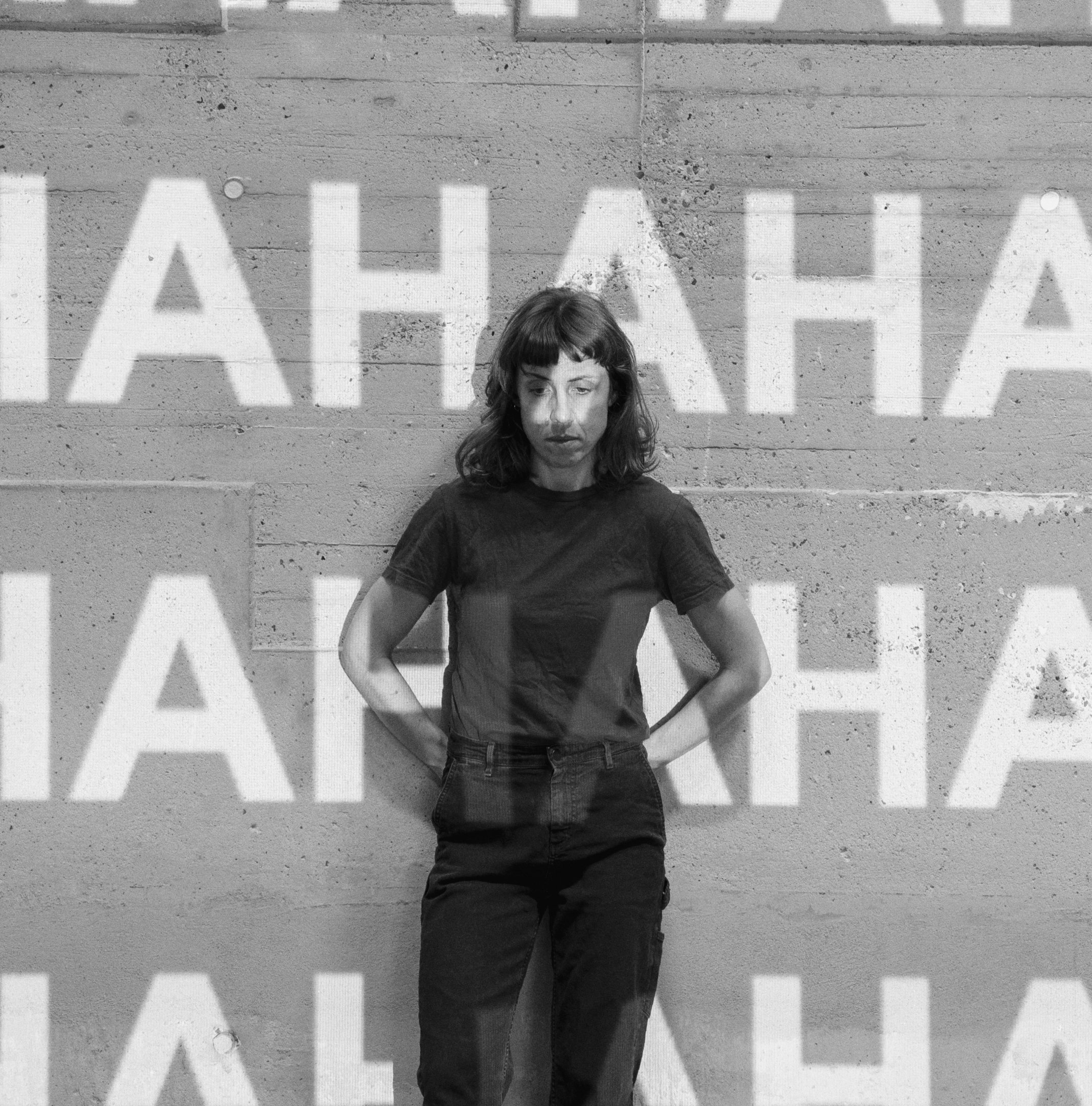 Full-length portrait of the artist, with superimposed writing projection