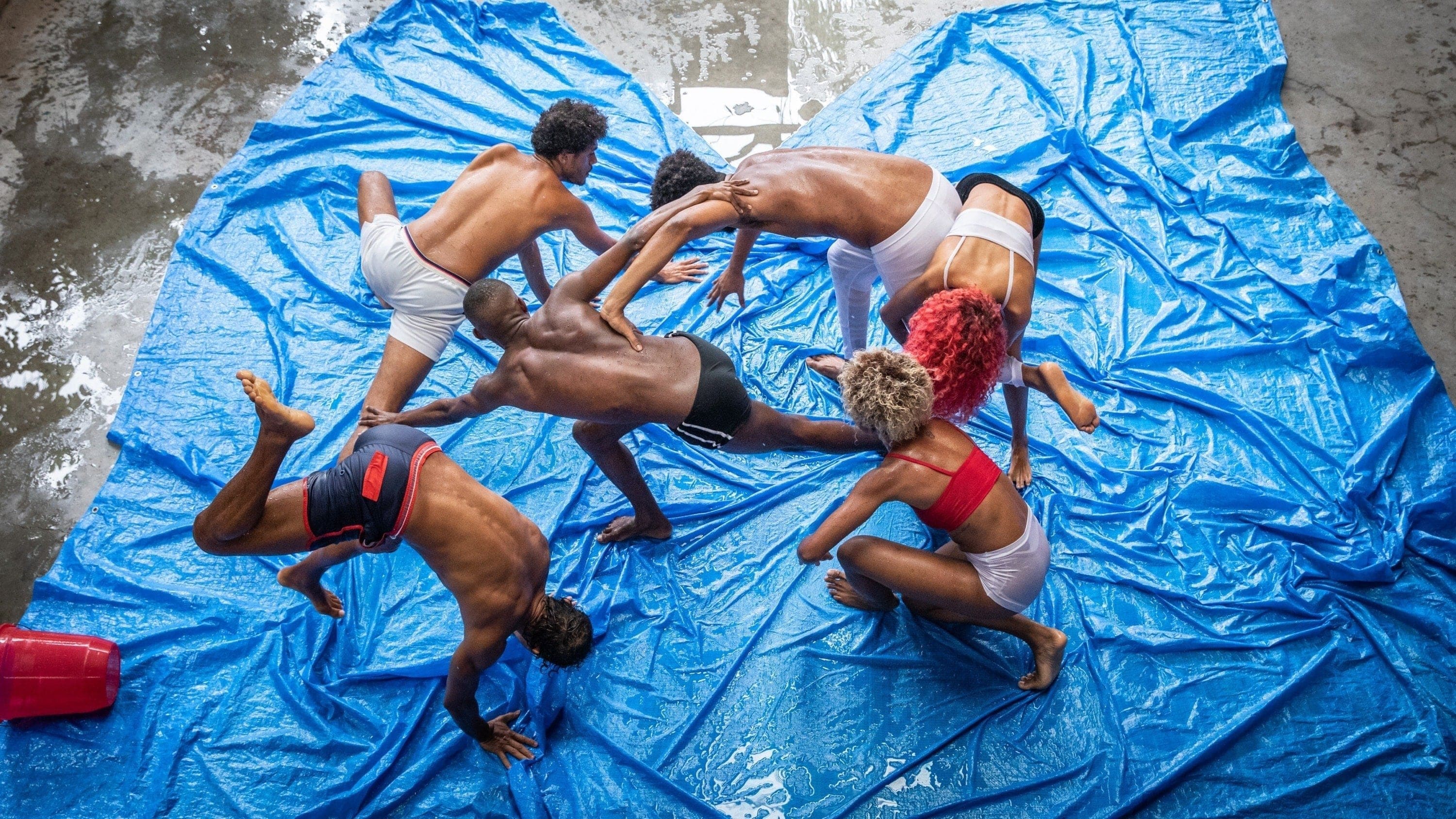 Dancers on a blue tarp