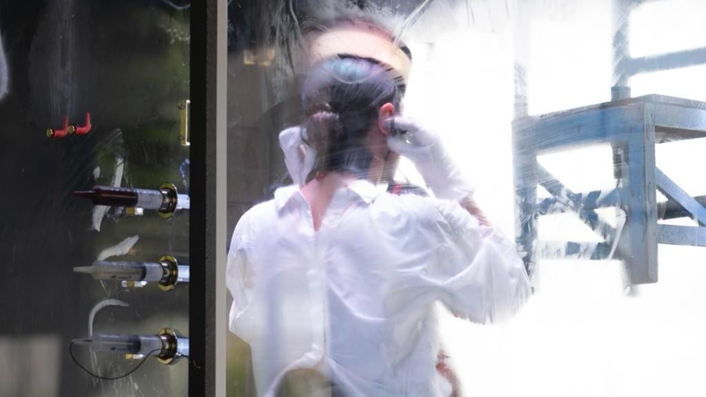 a person behind a glass with a white shirt