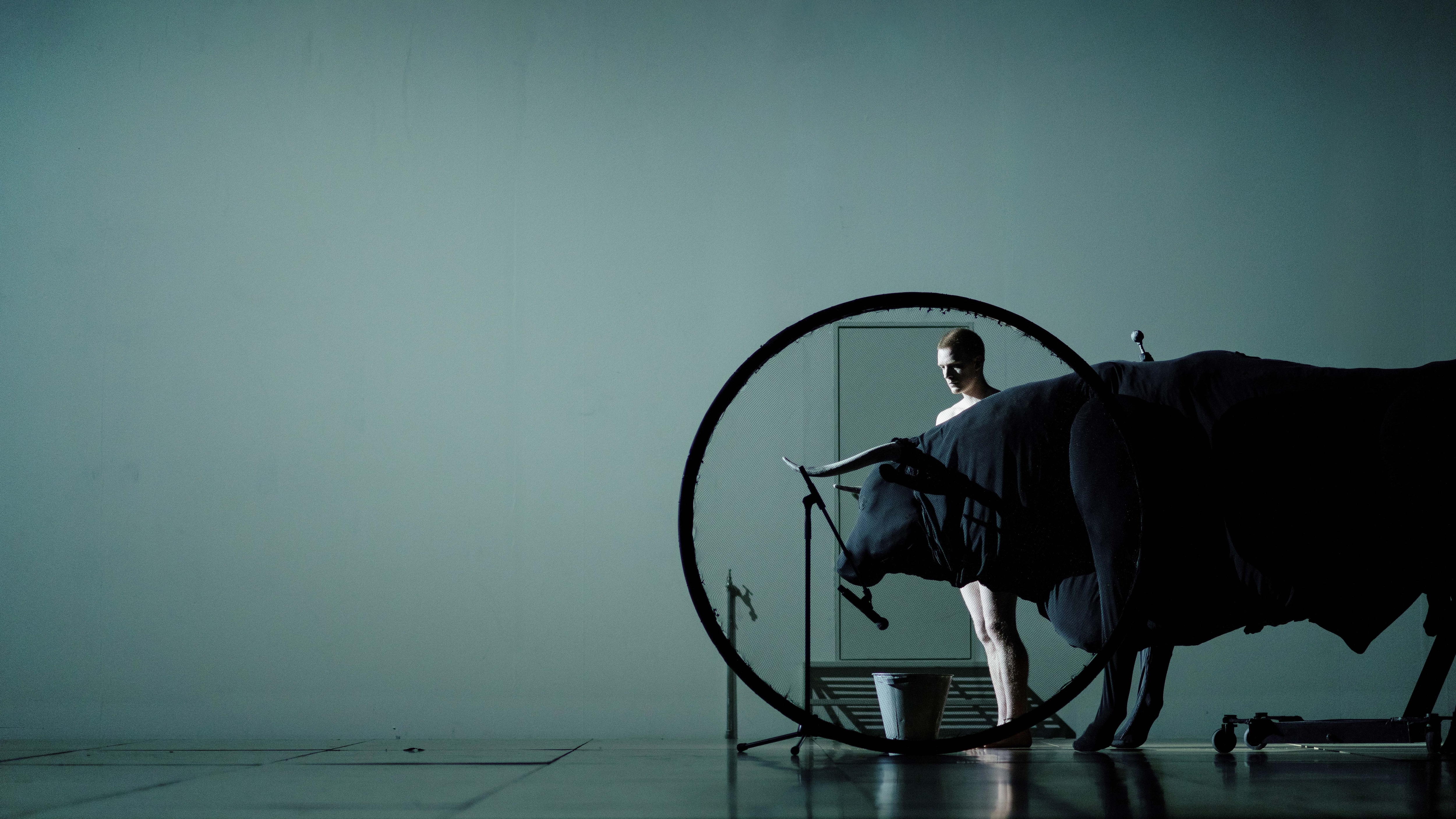 A dancer next to a bull in Transverse Orientation, from Dimitri Papaioannou