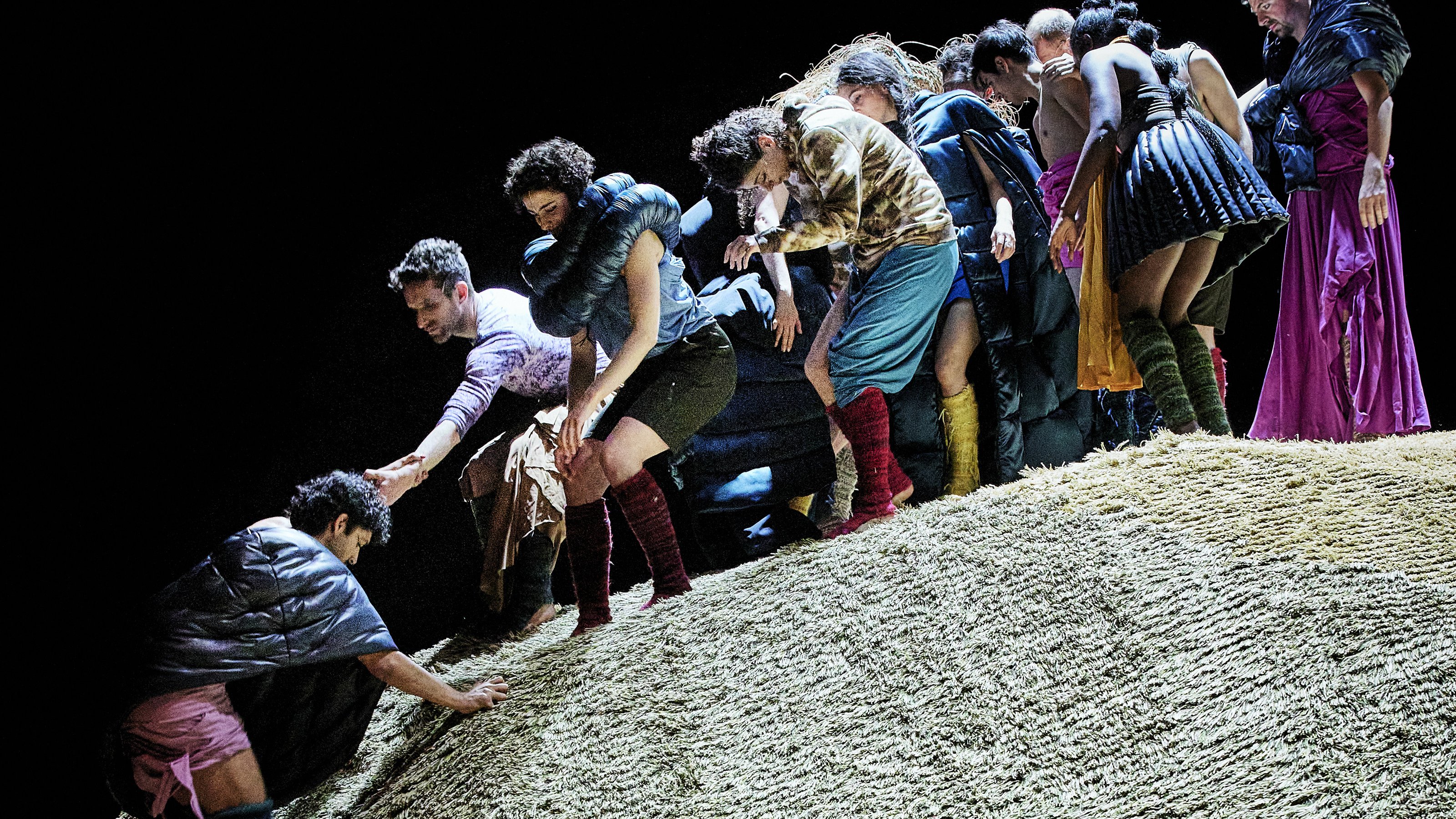 Dancers climbing on a mound