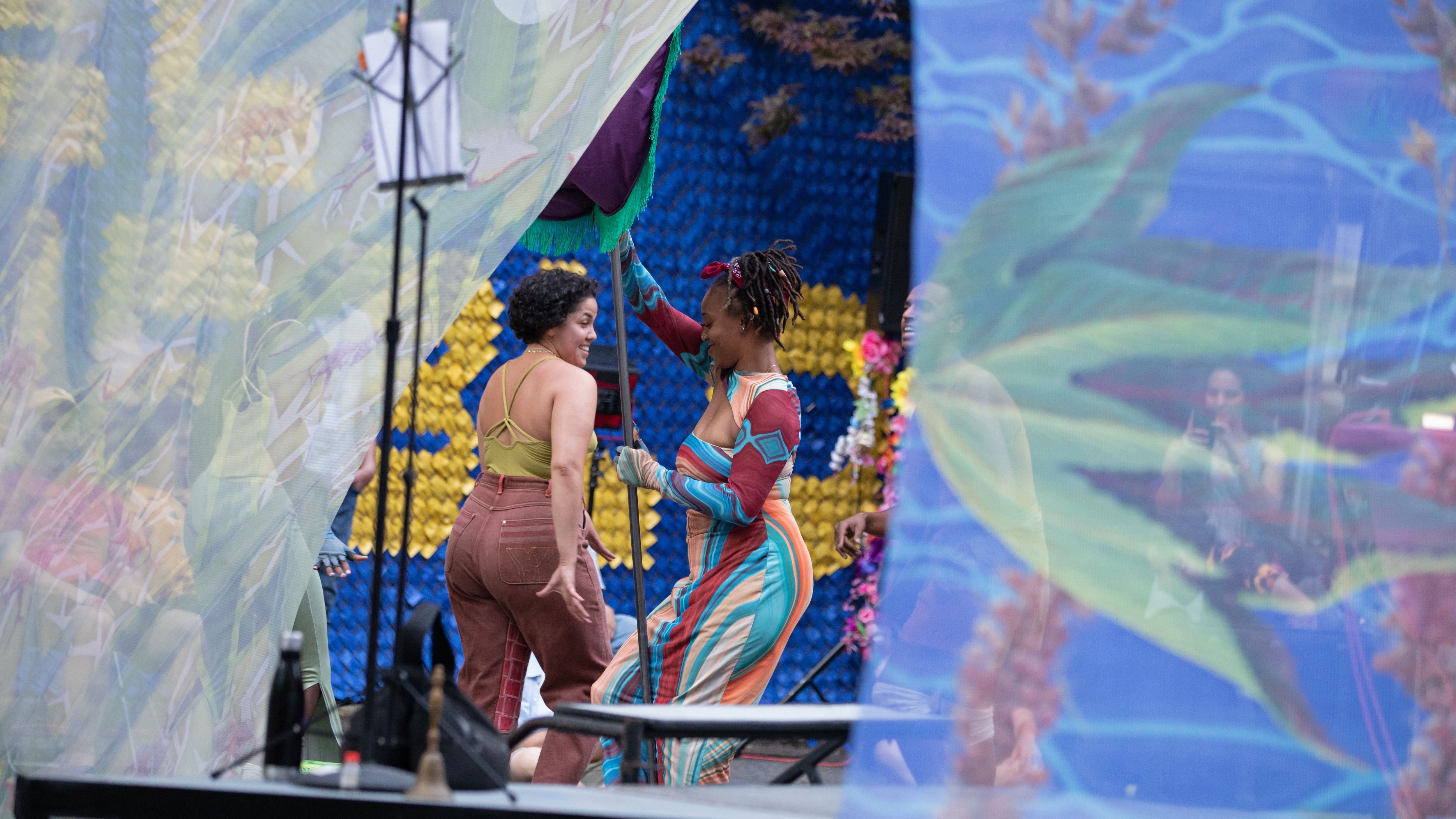 Two womens dancing, seen through veils