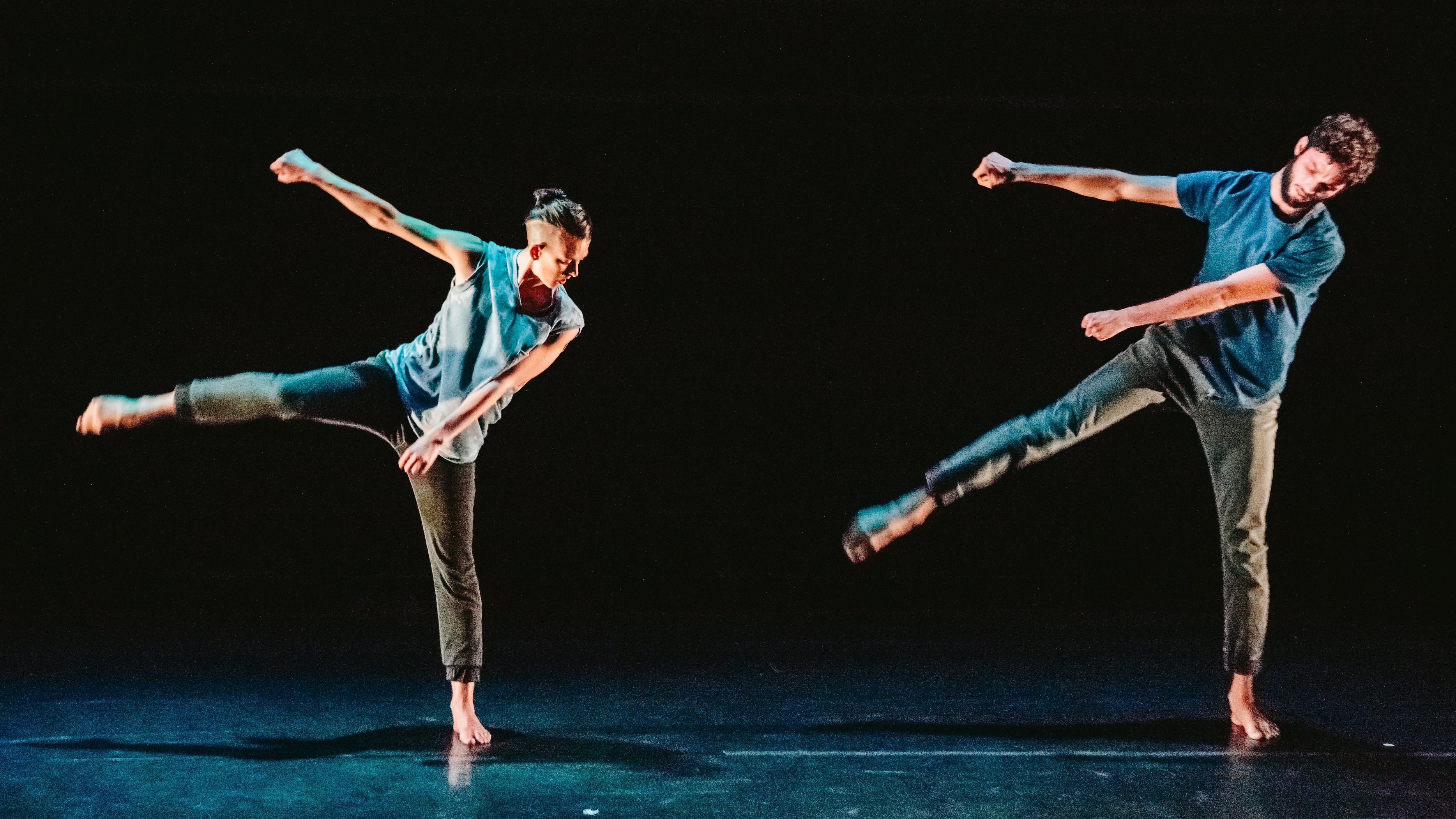 Two dancers with right leg up