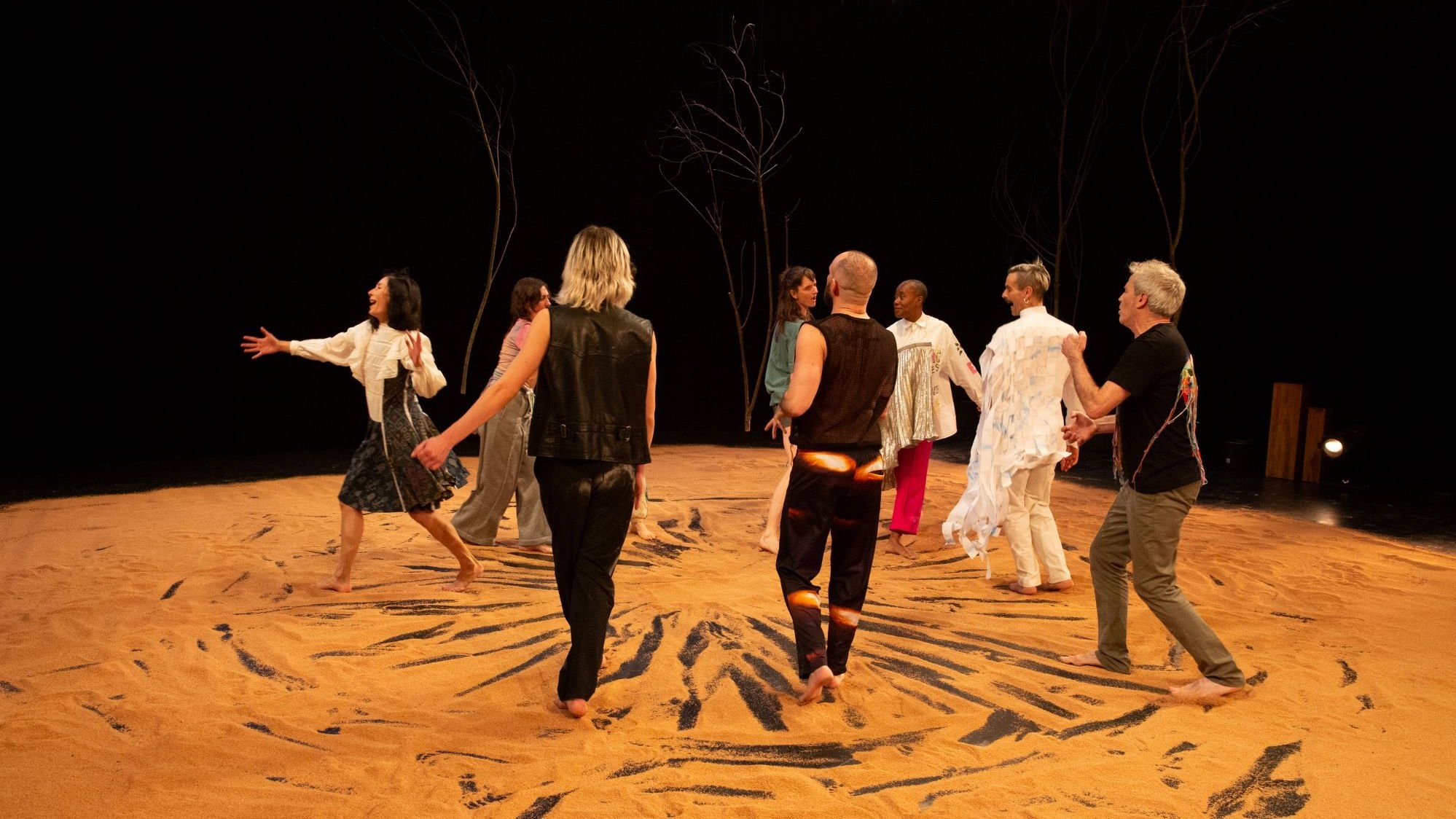 Dancers walking on sand in Kiss The One We Are by Daniel Linehan