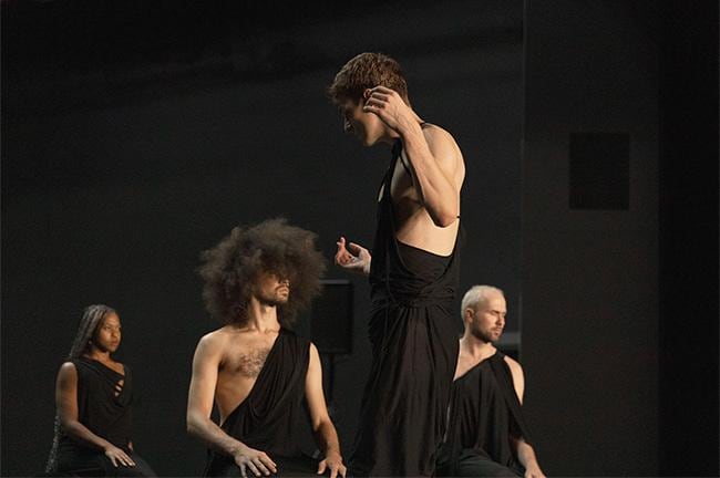 Dancers on stage dressed in black 