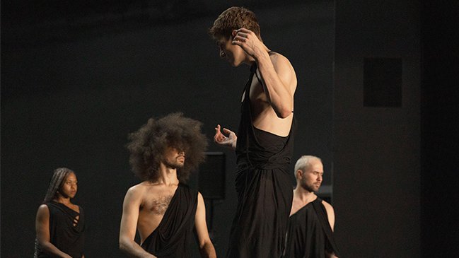 Dancers on stage dressed in black 