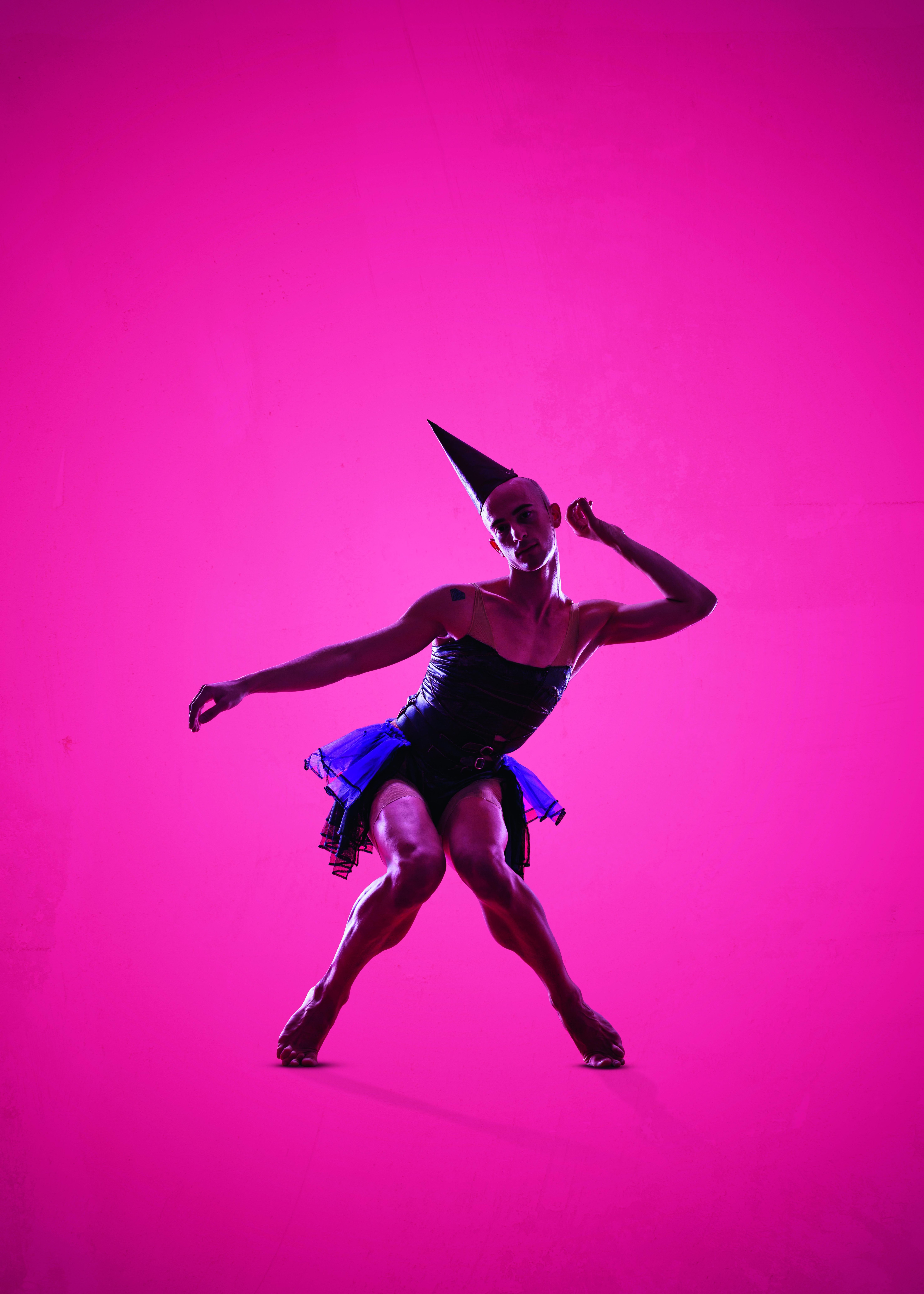 A dancer on a pink background in Ohad Naharin's Anafaza.