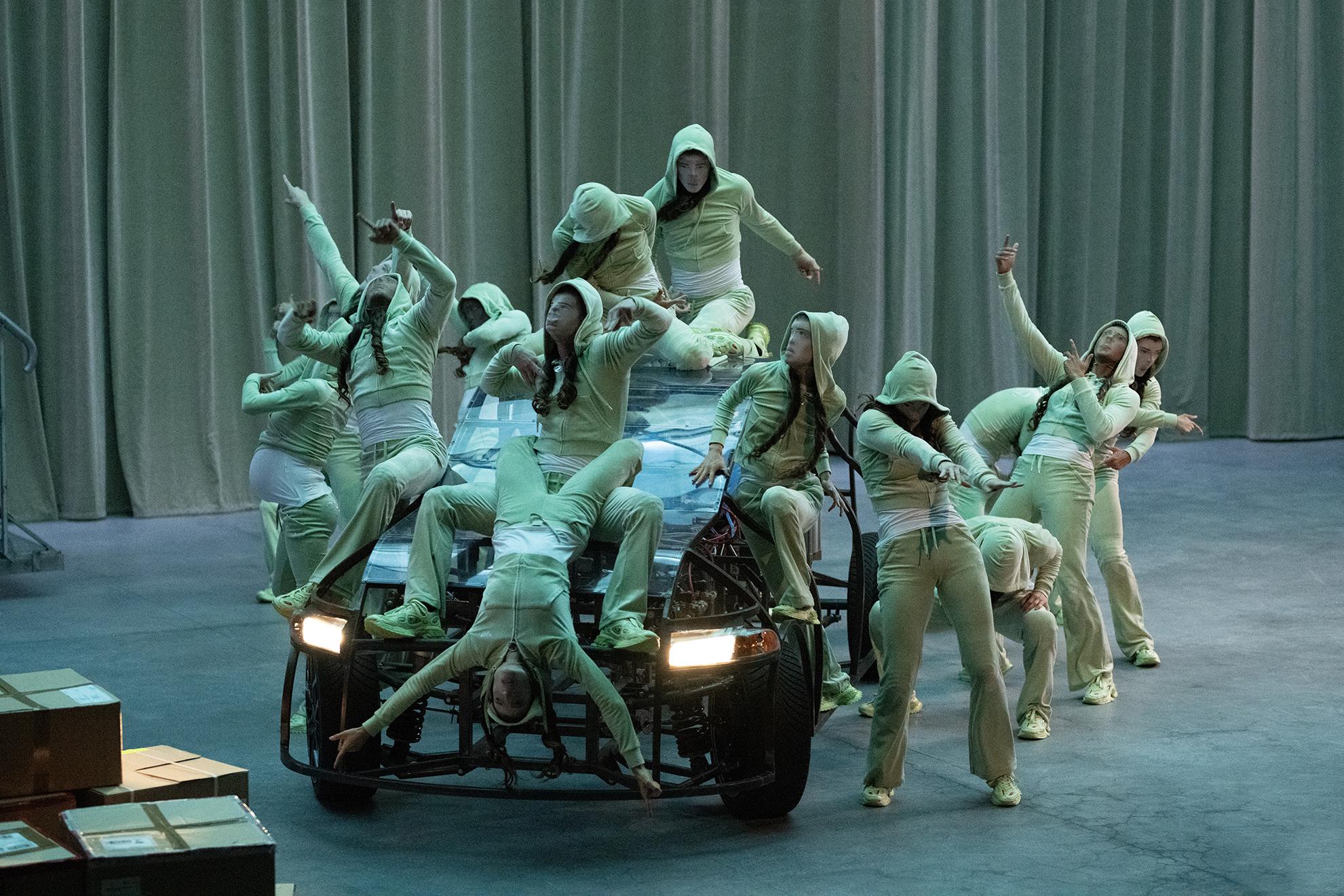 Masked dancers on a car