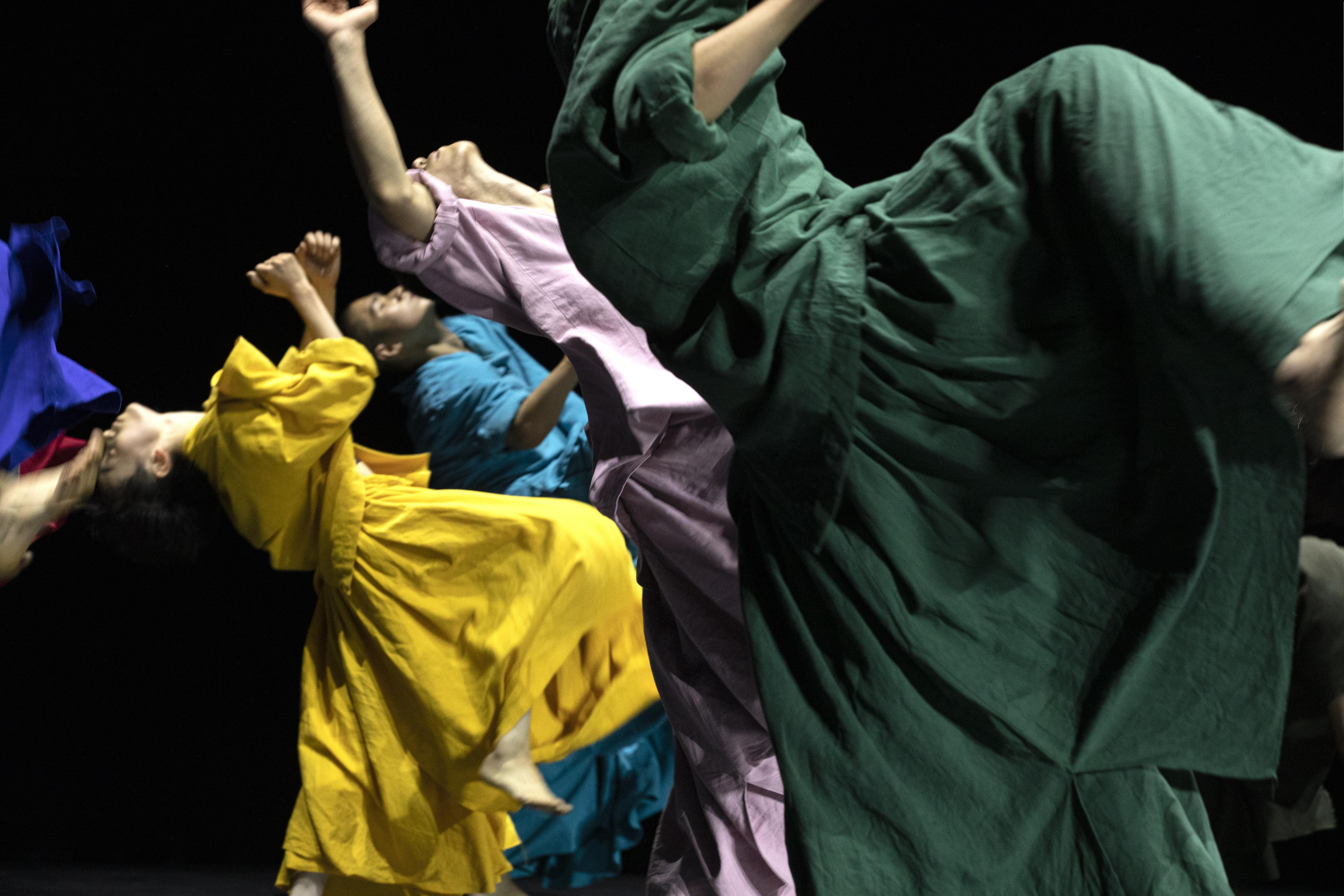 Dancers in colorful long dresses, excerpt from “14”