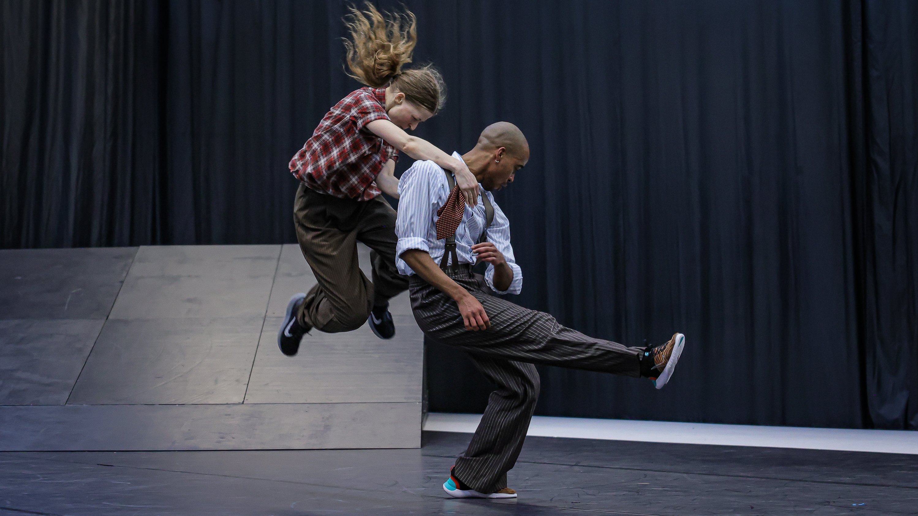 Two dancers jumping. 