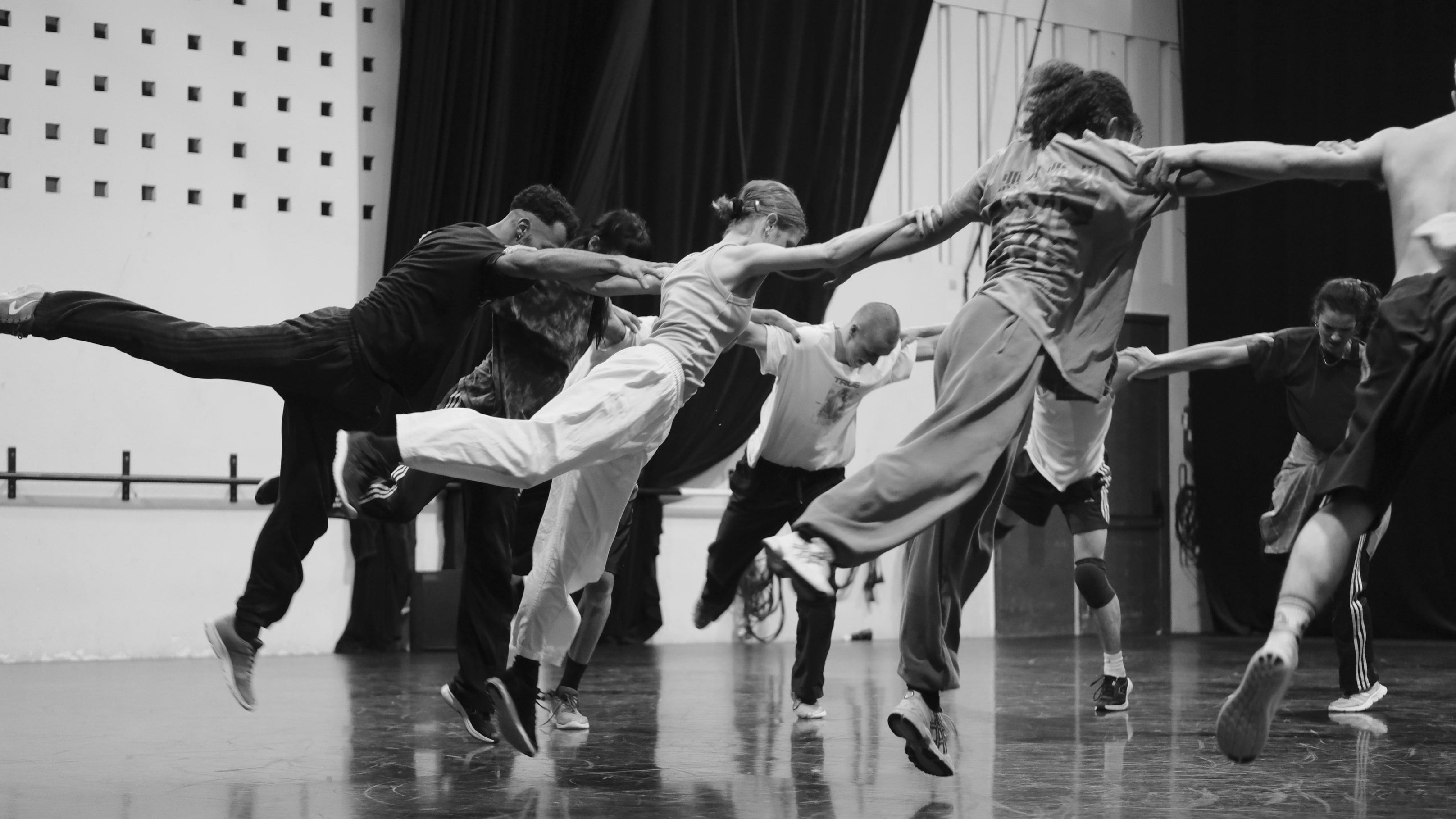 Group of dancers forming a circle during a workshop  