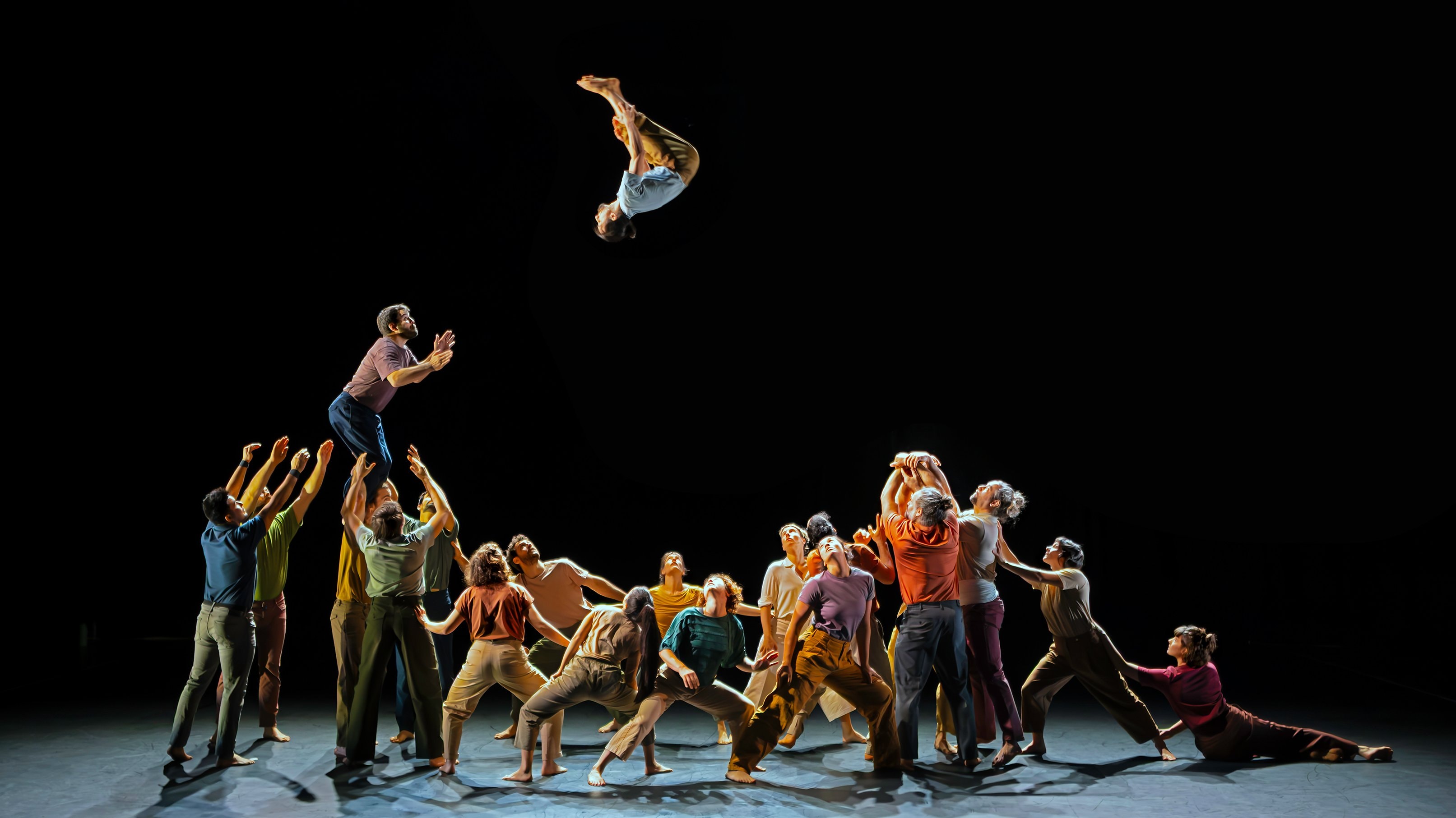 Group lift with a dancer performing a salto