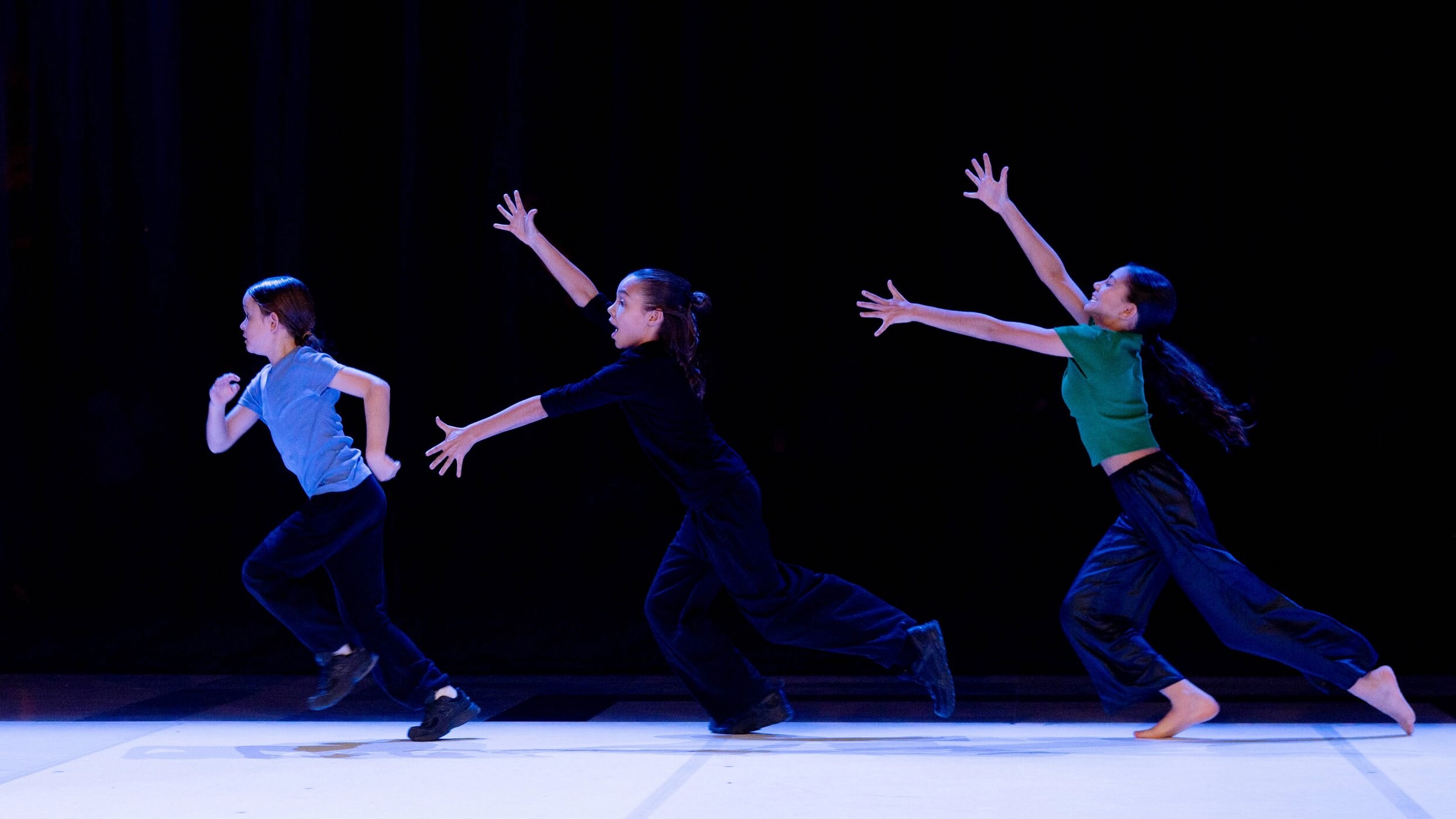 3 dancers performing on stage