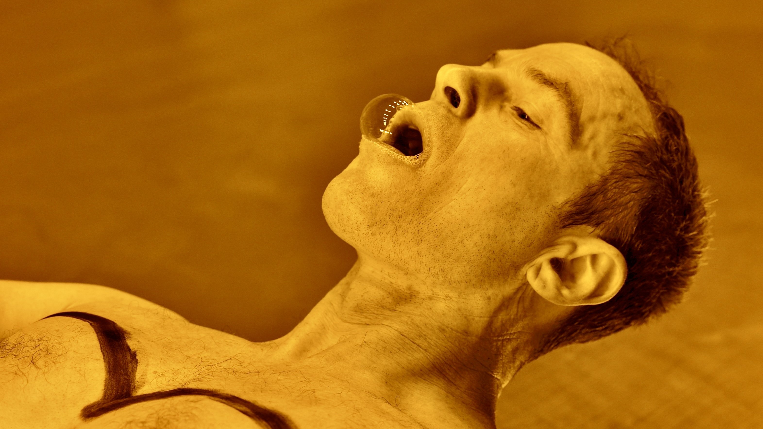 A dancer with a bubble in his mouth.