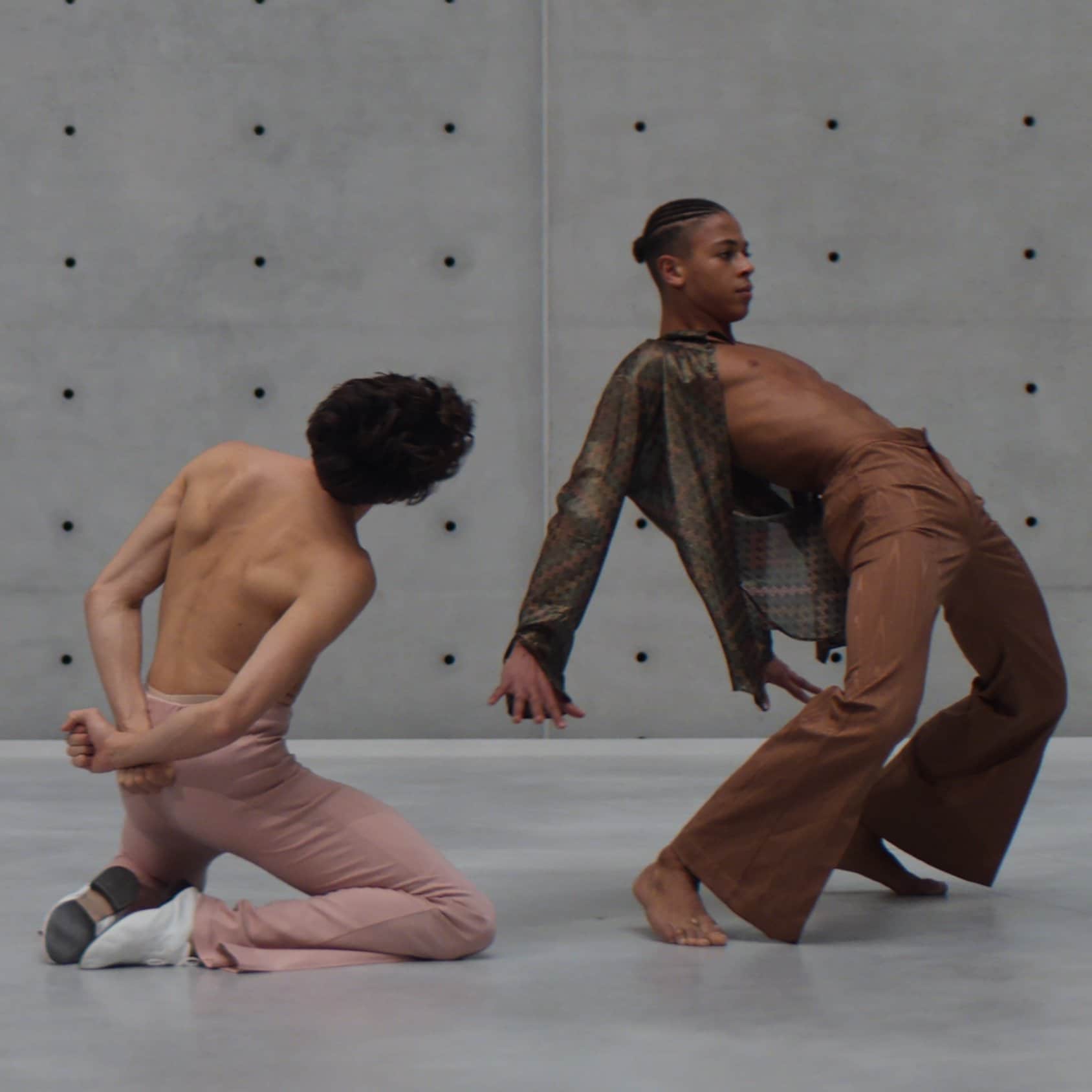 Two dancers on a grey background