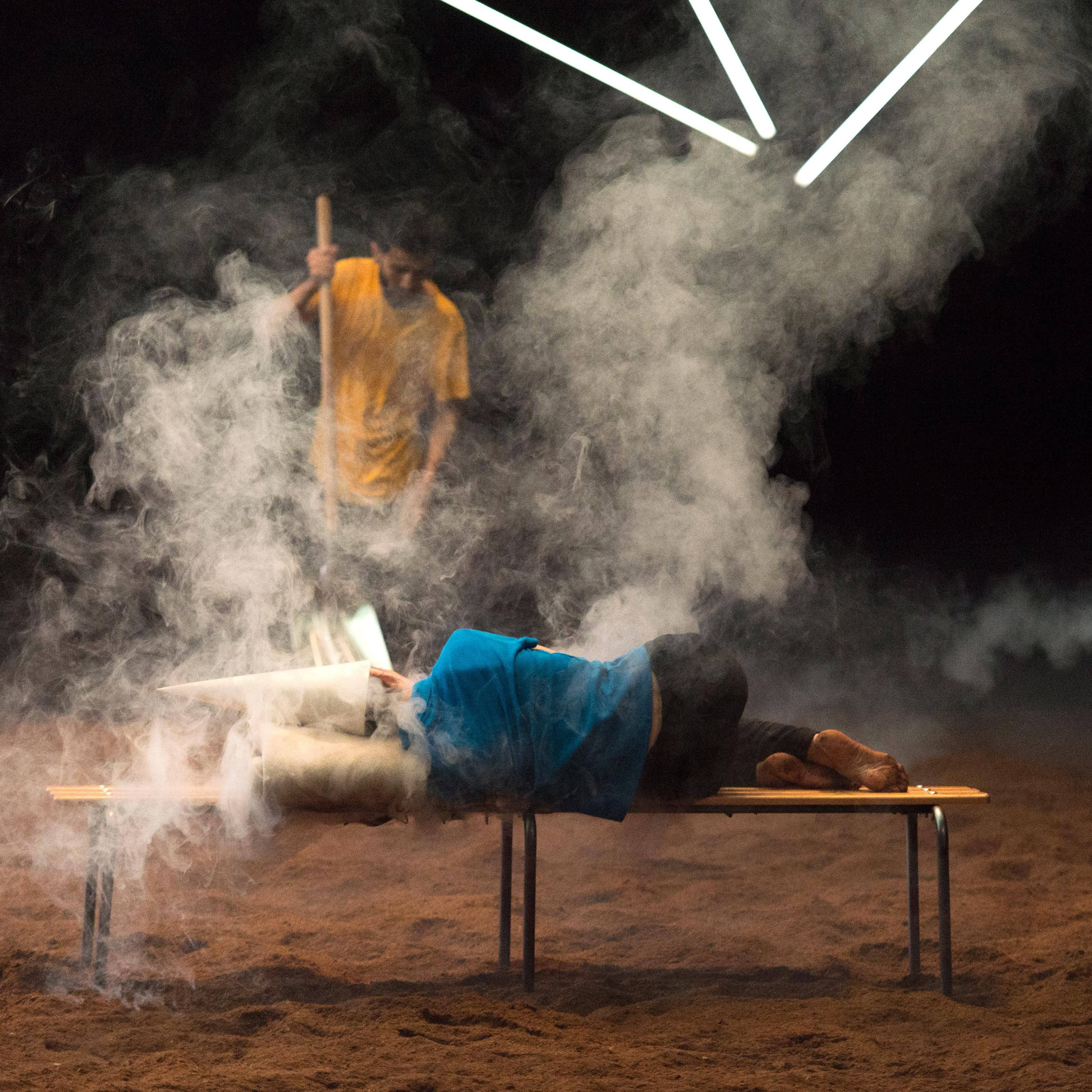 Danseur allongé sur un banc dans un nuage de fumée