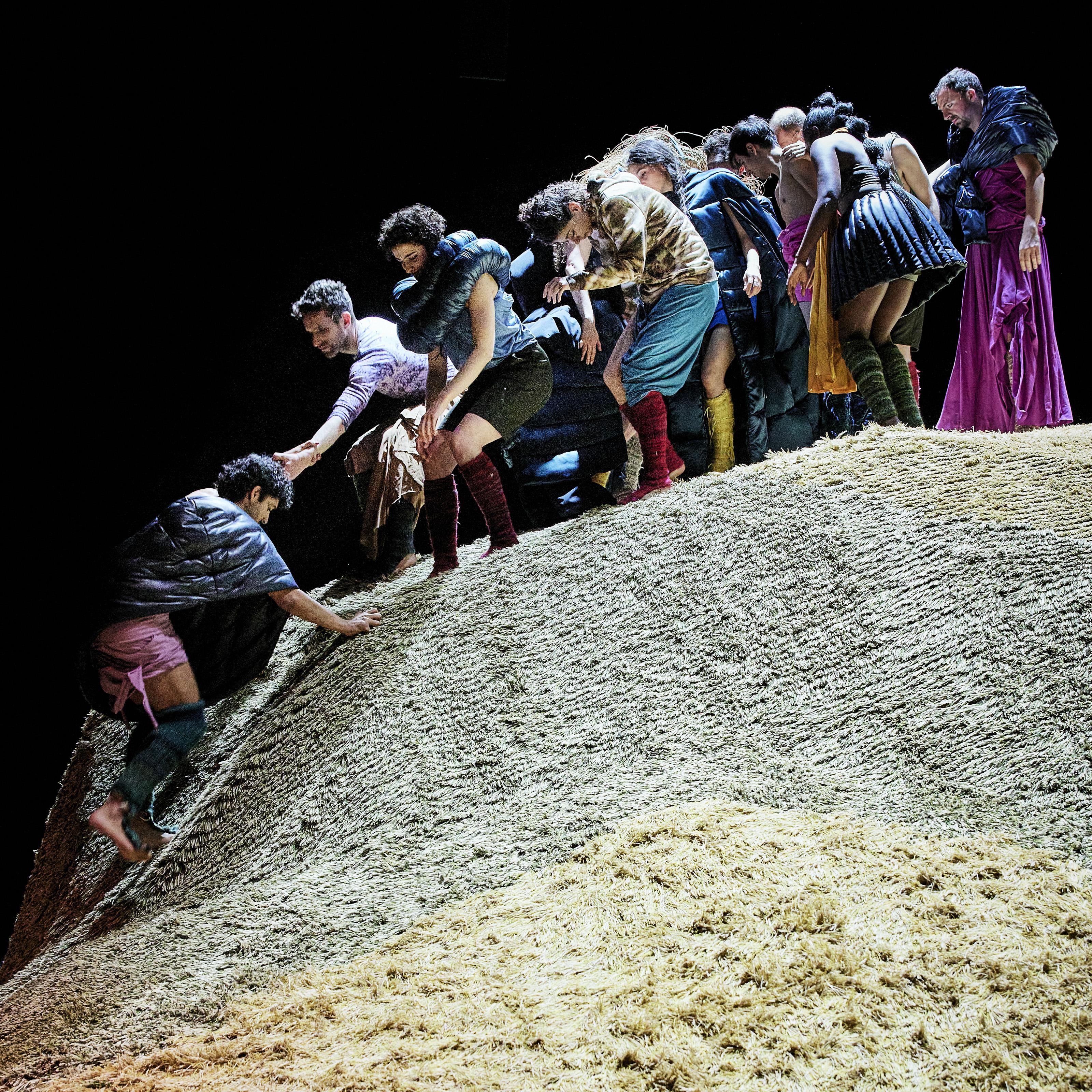 Dancers climbing on a mound