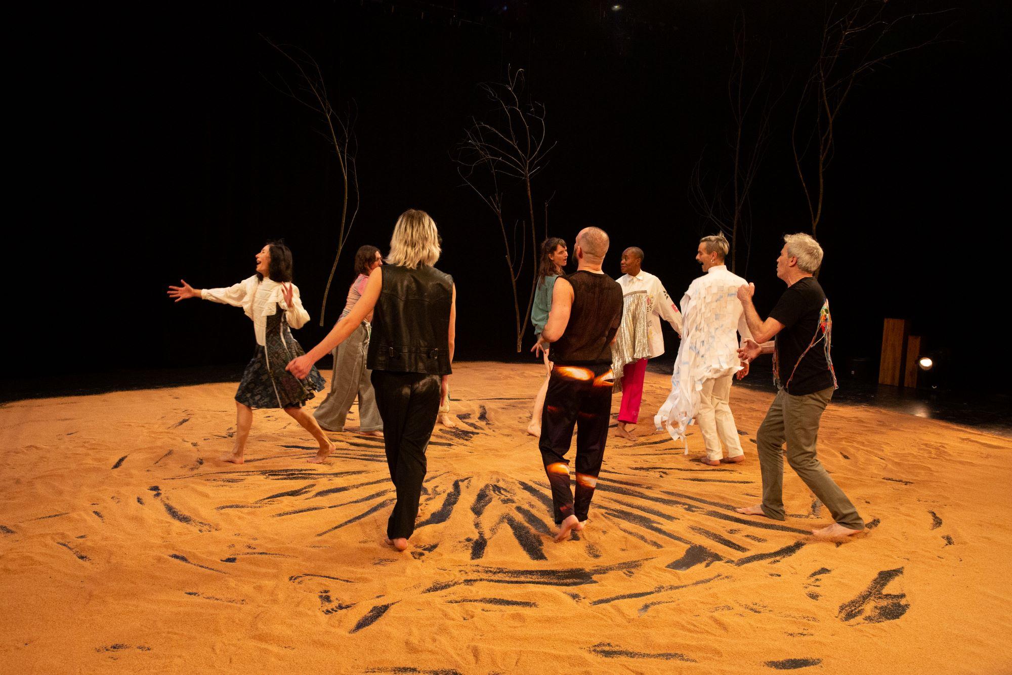 Dancers walking on sand in Kiss The One We Are by Daniel Linehan