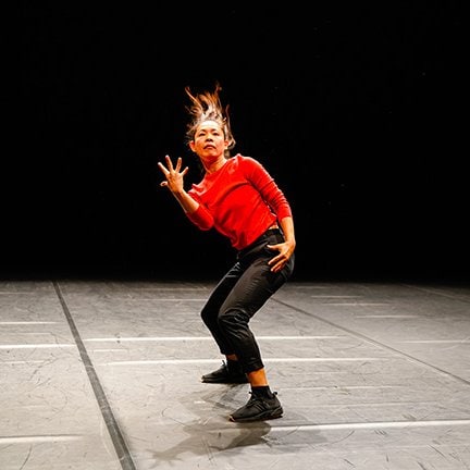 Dancer in red top in Le Sacre du Printemps by Xavier Le Roy