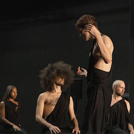 Dancers on stage dressed in black